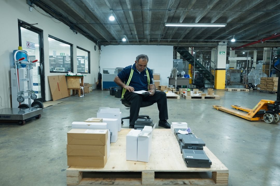 Colaborador preparando y verificando productos sobre pallet